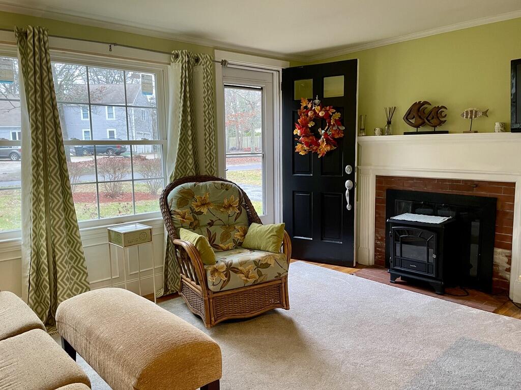 57 Suomi Road Hyannis, MA 02601 - Photo 3 of 11 a living room with furniture a fireplace and a window