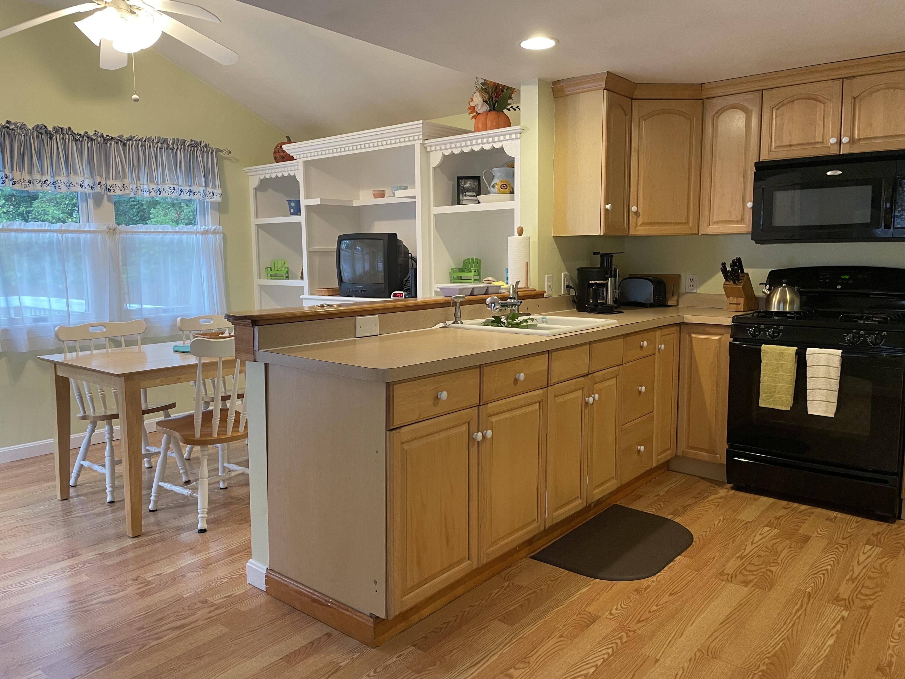 57 Suomi Road Hyannis, MA 02601 - Photo 6 of 11 a kitchen with stainless steel appliances granite countertop a sink a stove and cabinets