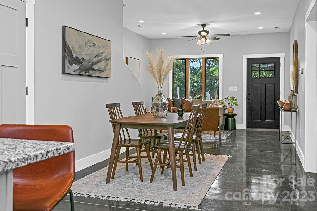 183 Neely Road Brevard, NC 28712 - Photo 14 of 44 a view of a a dining room with furniture window and wooden floor