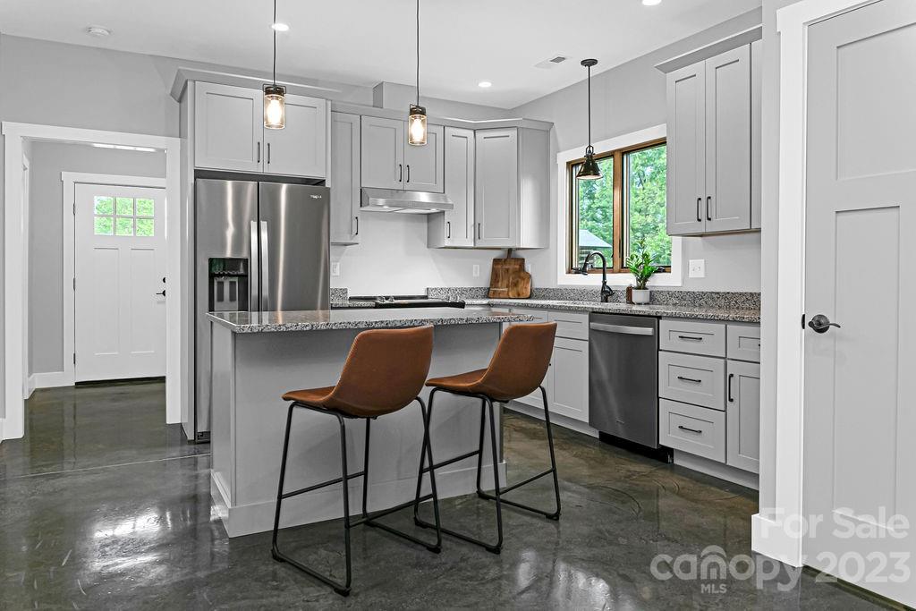 183 Neely Road Brevard, NC 28712 - Photo 2 of 44 a kitchen with stainless steel appliances granite countertop a sink a stove a refrigerator and island with wooden floor