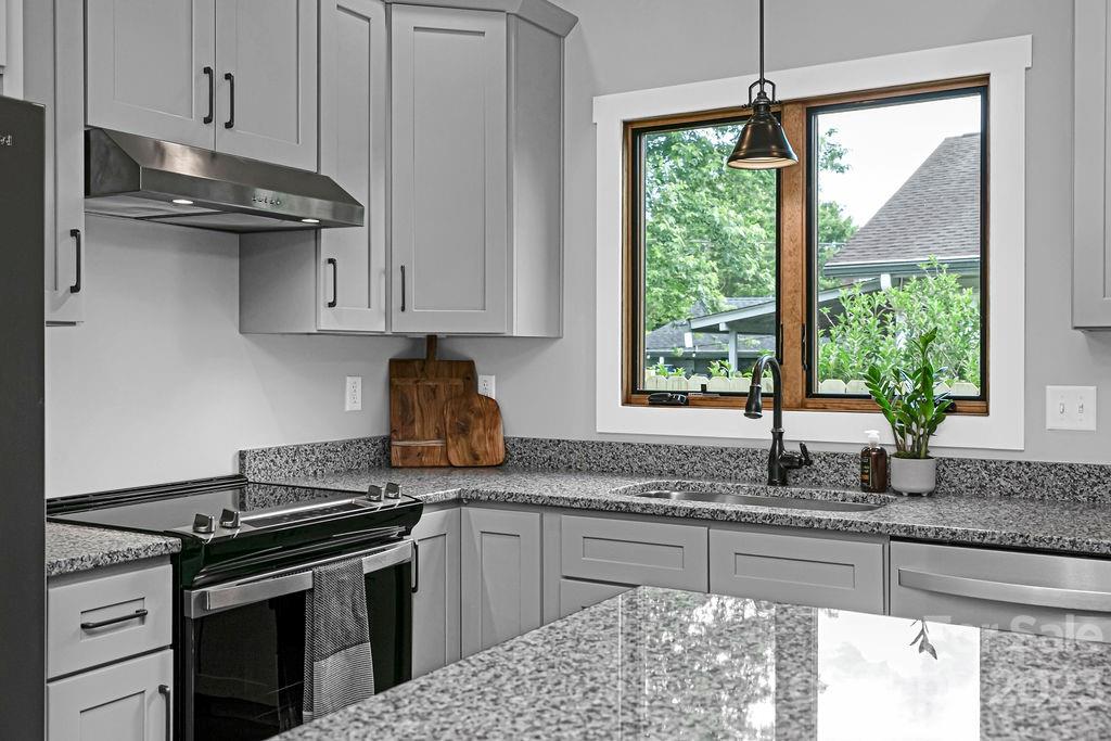183 Neely Road Brevard, NC 28712 - Photo 3 of 44 a kitchen with granite countertop a sink a stove and a granite counter tops