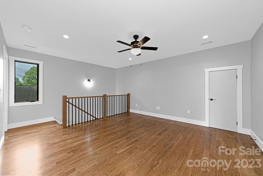 183 Neely Road Brevard, NC 28712 - Photo 31 of 44 a view of an empty room with a window and wooden floor