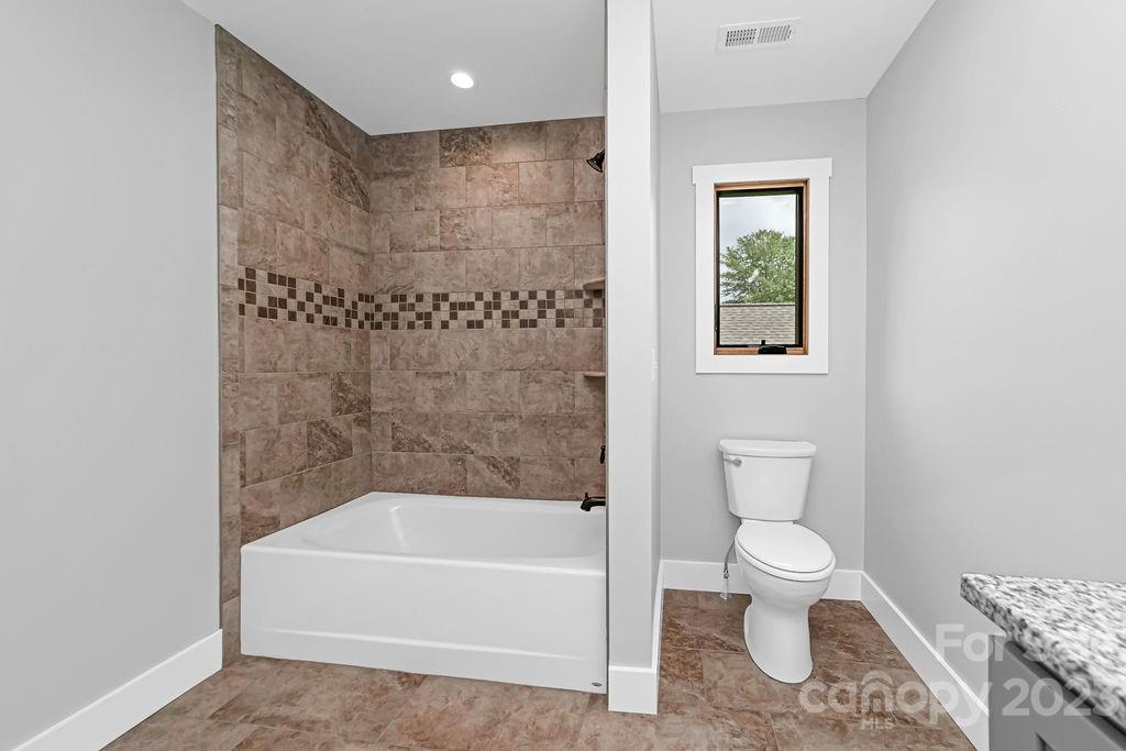 183 Neely Road Brevard, NC 28712 - Photo 35 of 44 a bathroom with a toilet and a bathtub