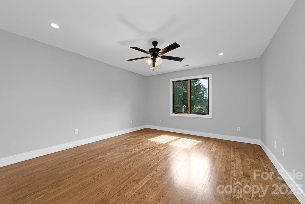 183 Neely Road Brevard, NC 28712 - Photo 37 of 44 an empty room with wooden floor and windows
