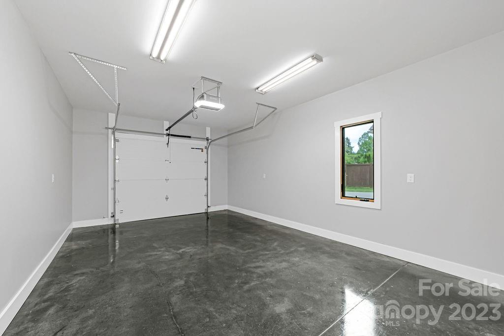 183 Neely Road Brevard, NC 28712 - Photo 39 of 44 an empty room with ceiling fan and windows