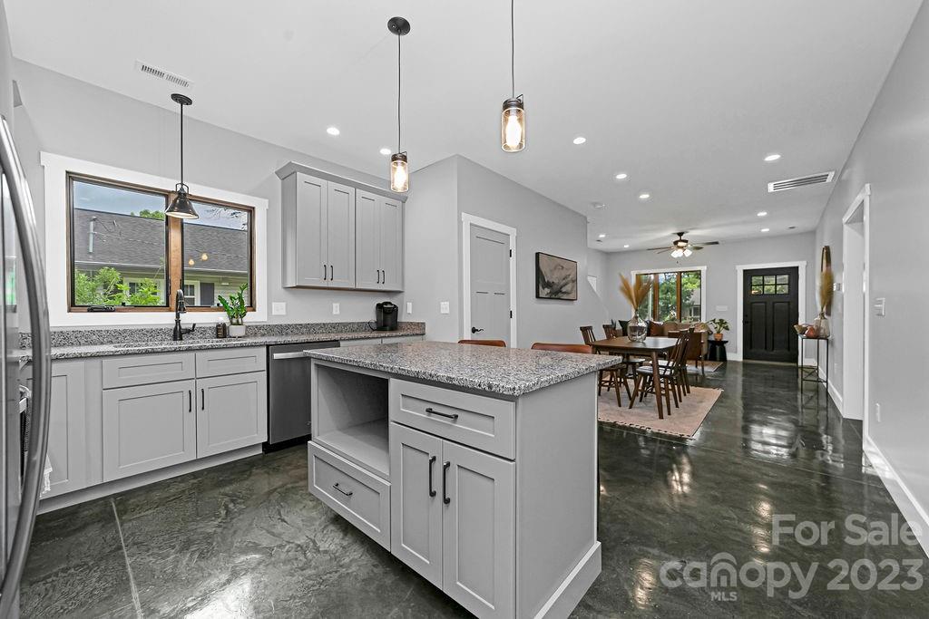 183 Neely Road Brevard, NC 28712 - Photo 4 of 44 a large kitchen with lots of counter space dining table and chairs