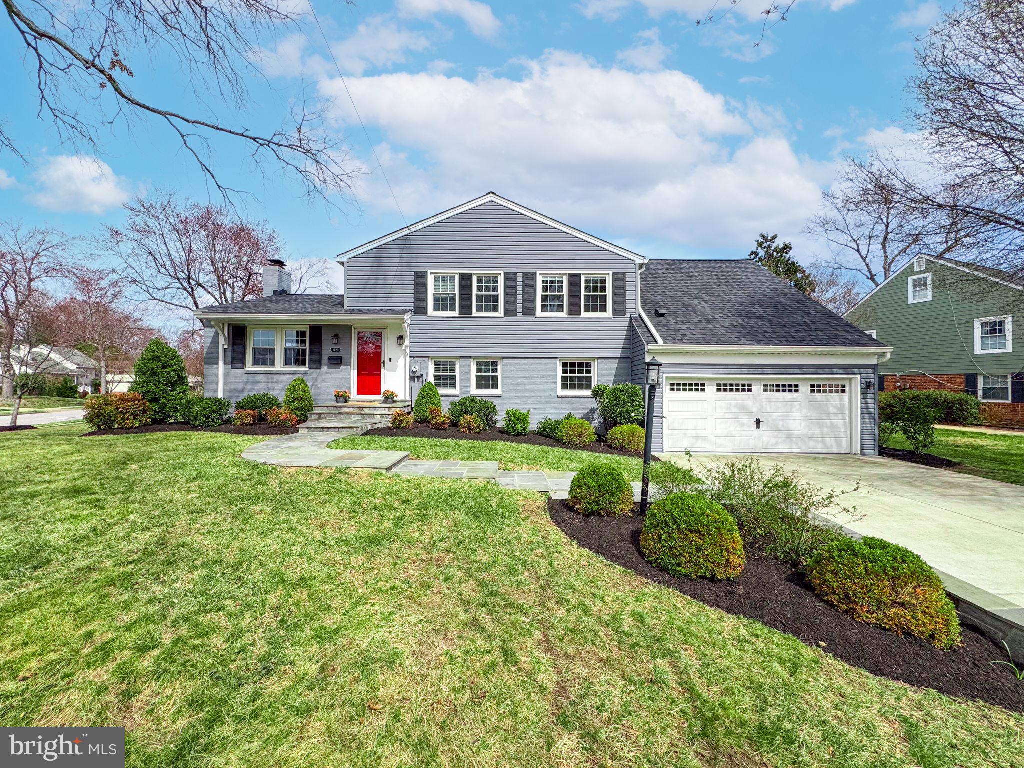 1122 Waynewood Boulevard Alexandria, VA 22308 - Photo 1 of 51 a front view of a house with a yard and garage