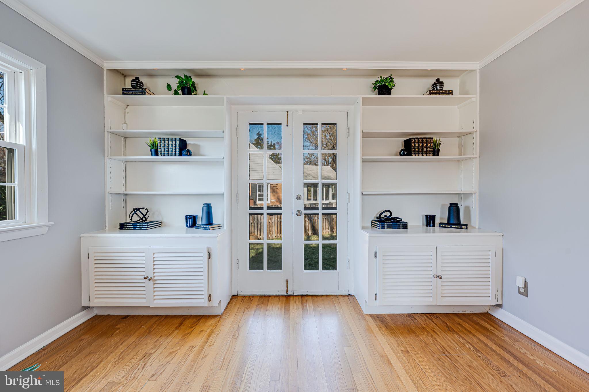 1122 Waynewood Boulevard Alexandria, VA 22308 - Photo 14 of 51 a room with a baby crib and a wooden floor