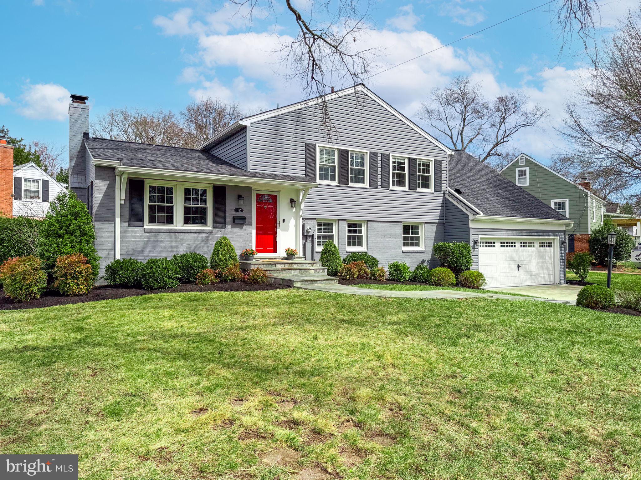1122 Waynewood Boulevard Alexandria, VA 22308 - Photo 2 of 51 a front view of a house with a yard and garage