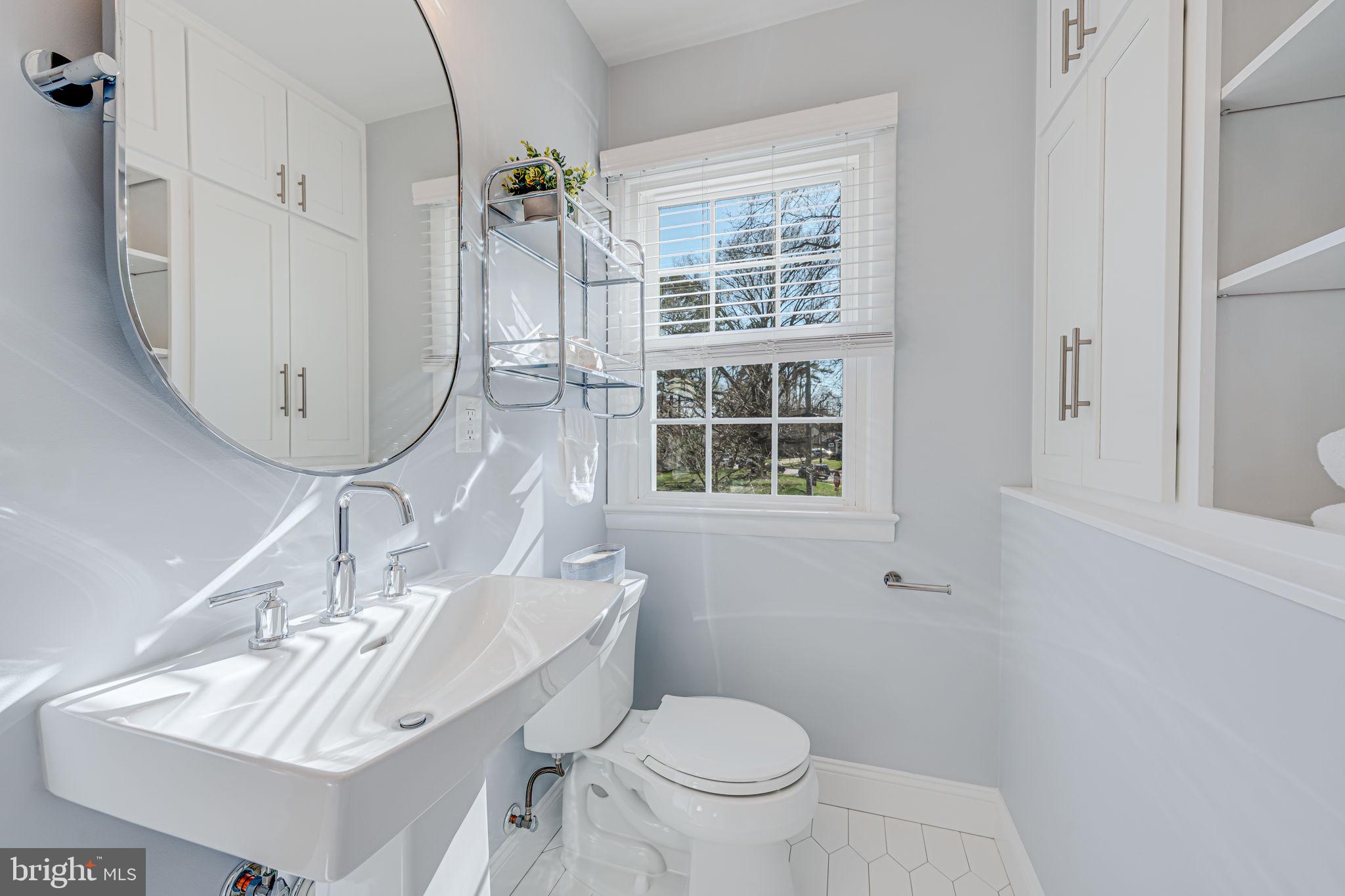 1122 Waynewood Boulevard Alexandria, VA 22308 - Photo 30 of 51 a bathroom with a sink a toilet and a mirror