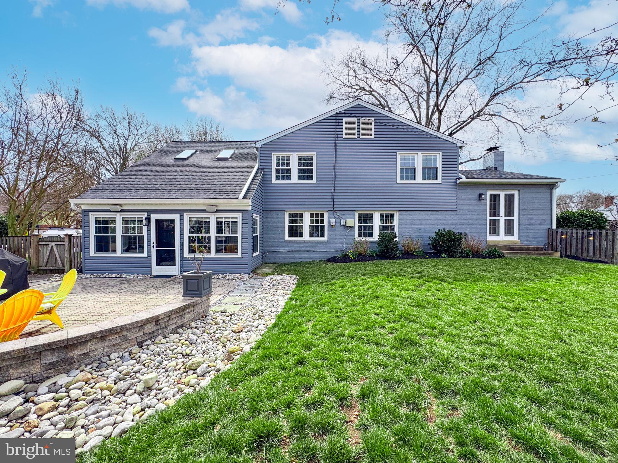 1122 Waynewood Boulevard Alexandria, VA 22308 - Photo 36 of 51 a front view of a house with a yard table and chairs