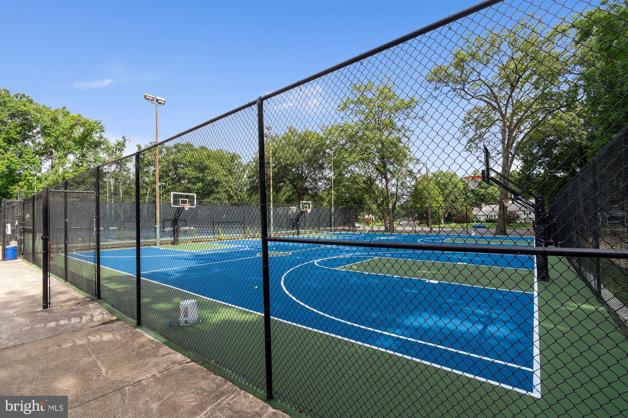 1122 Waynewood Boulevard Alexandria, VA 22308 - Photo 44 of 51 a view of a tennis court with large trees