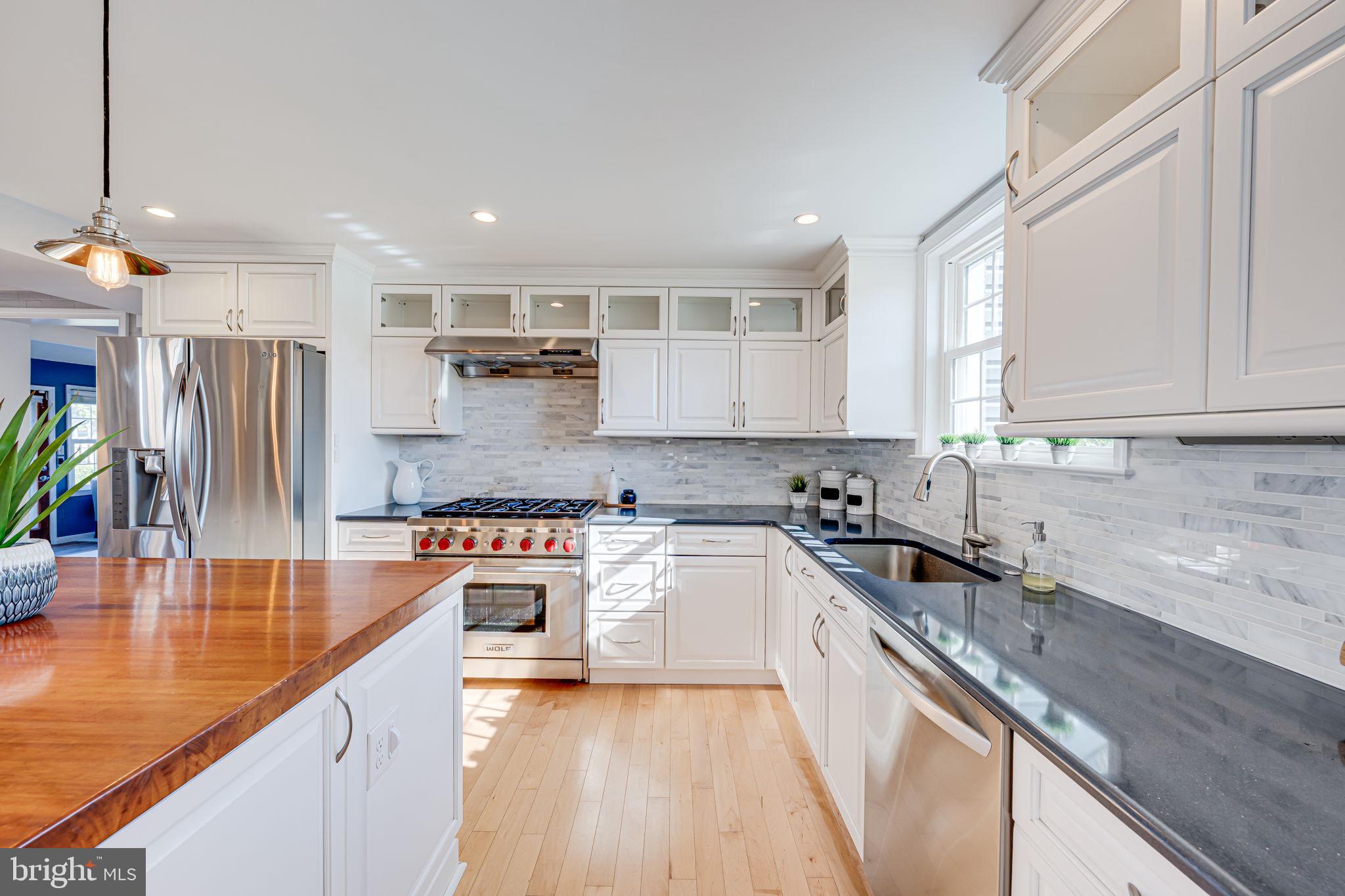 1122 Waynewood Boulevard Alexandria, VA 22308 - Photo 5 of 51 a kitchen with stainless steel appliances granite countertop a sink stove and refrigerator