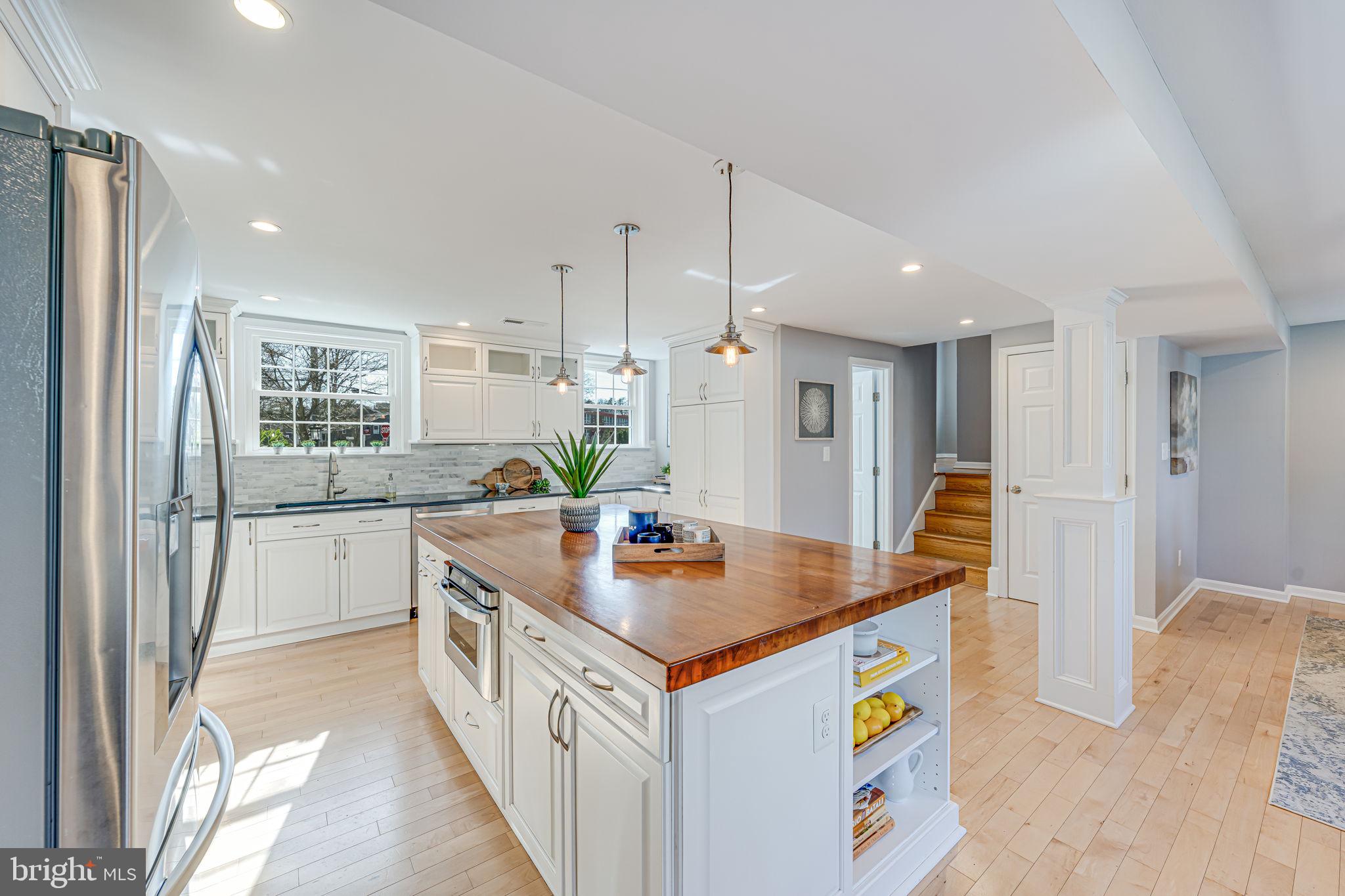 1122 Waynewood Boulevard Alexandria, VA 22308 - Photo 6 of 51 a kitchen that has a lot of cabinets in it and wooden floor