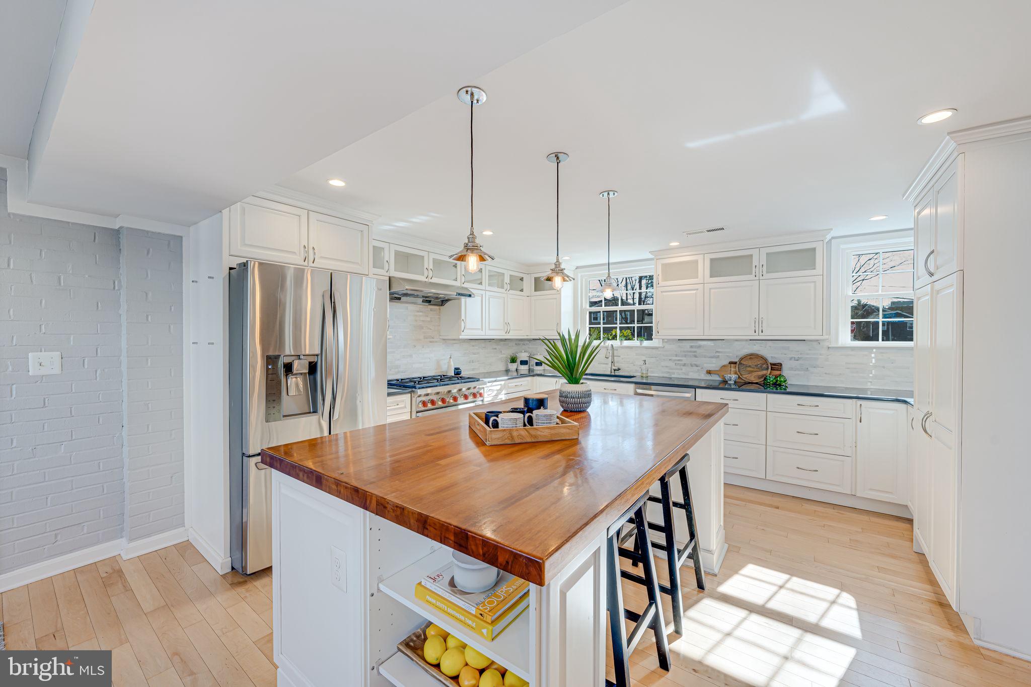 1122 Waynewood Boulevard Alexandria, VA 22308 - Photo 7 of 51 a kitchen with stainless steel appliances granite countertop a refrigerator a sink a stove and white cabinets