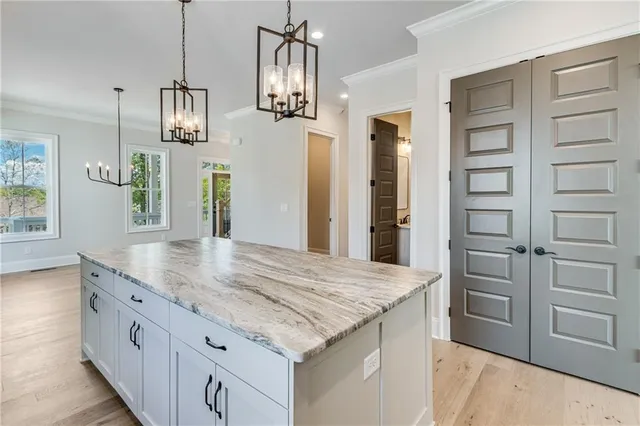 a kitchen with kitchen island cabinets and wooden floor