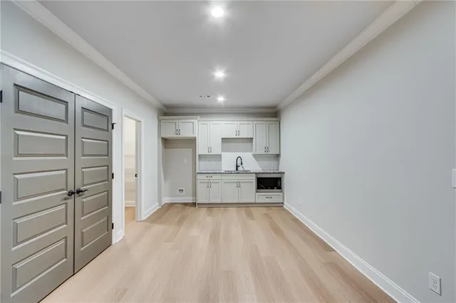 a view of walk in closet with clothes