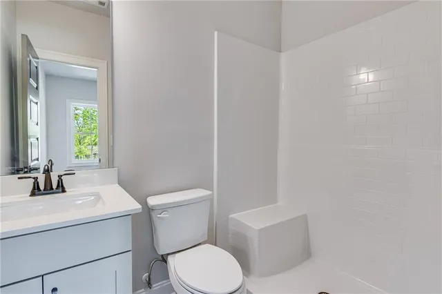 a view of an empty room and a bathroom