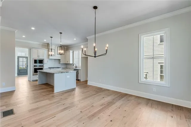 a view of kitchen with refrigerator and window