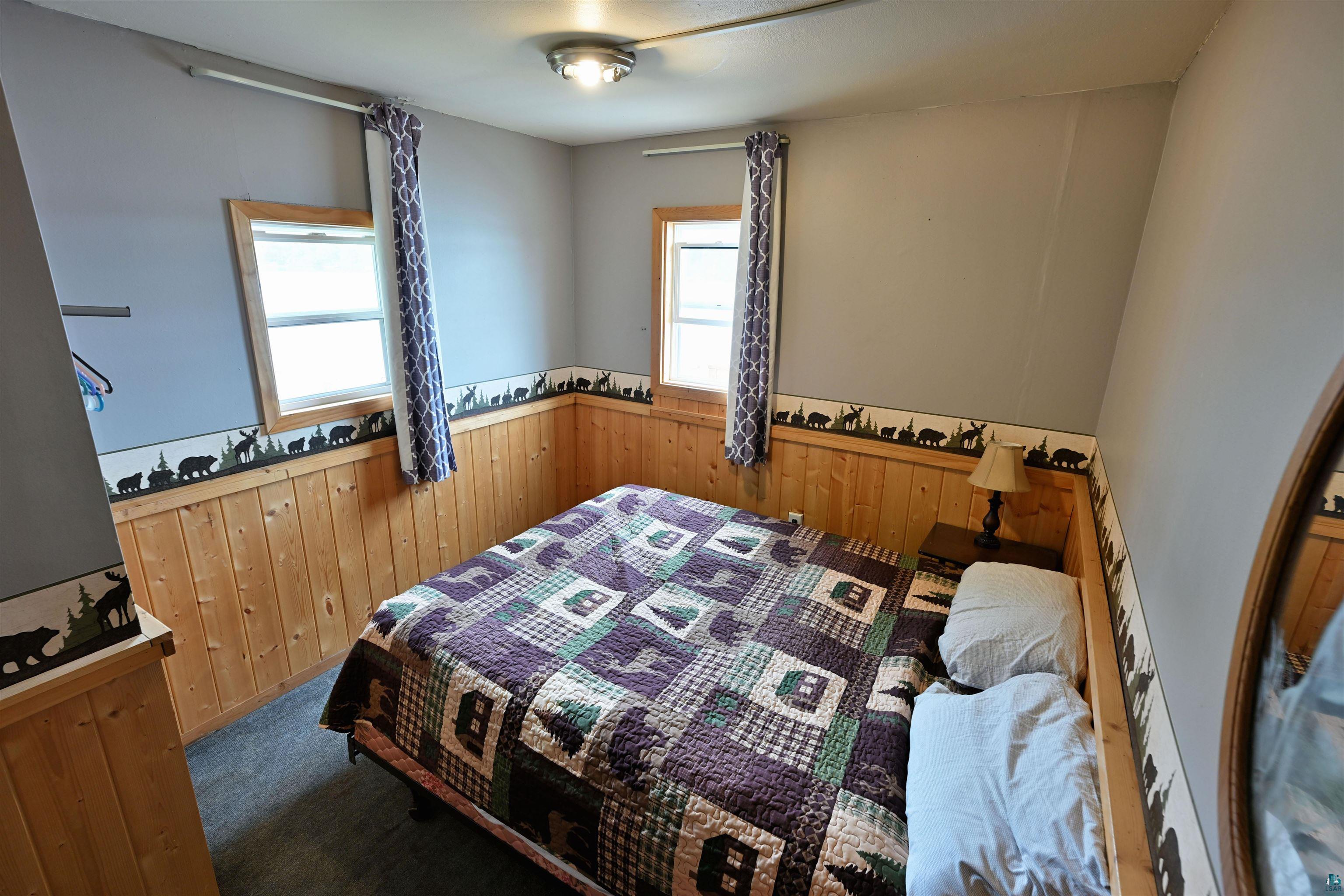 6833 View Point Lodge Road Gordon, WI 54838 - Photo 24 of 40 Bedroom featuring wainscoting and wooden walls