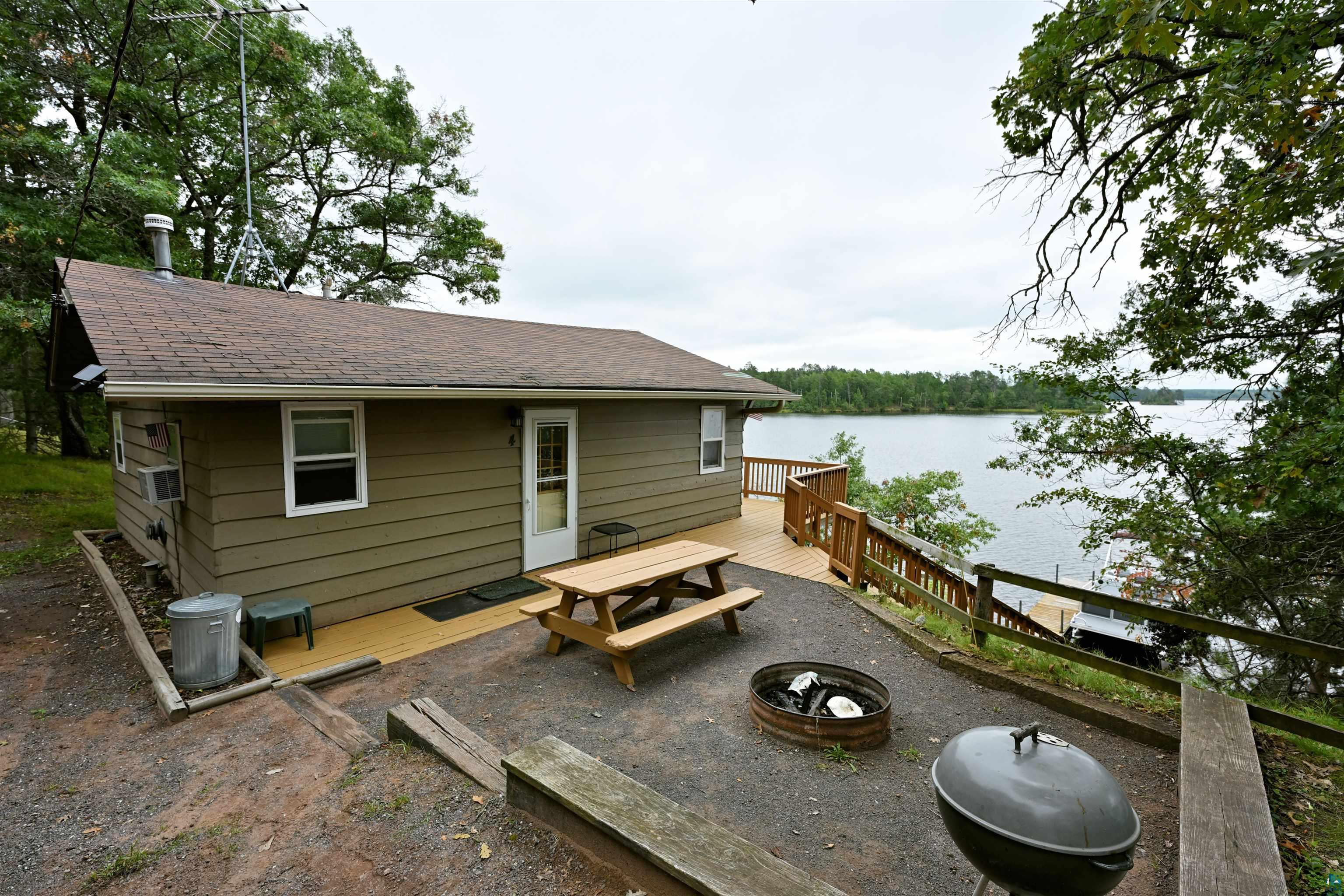 6833 View Point Lodge Road Gordon, WI 54838 - Photo 28 of 40 View of patio / terrace featuring a fire pit and a deck with water view