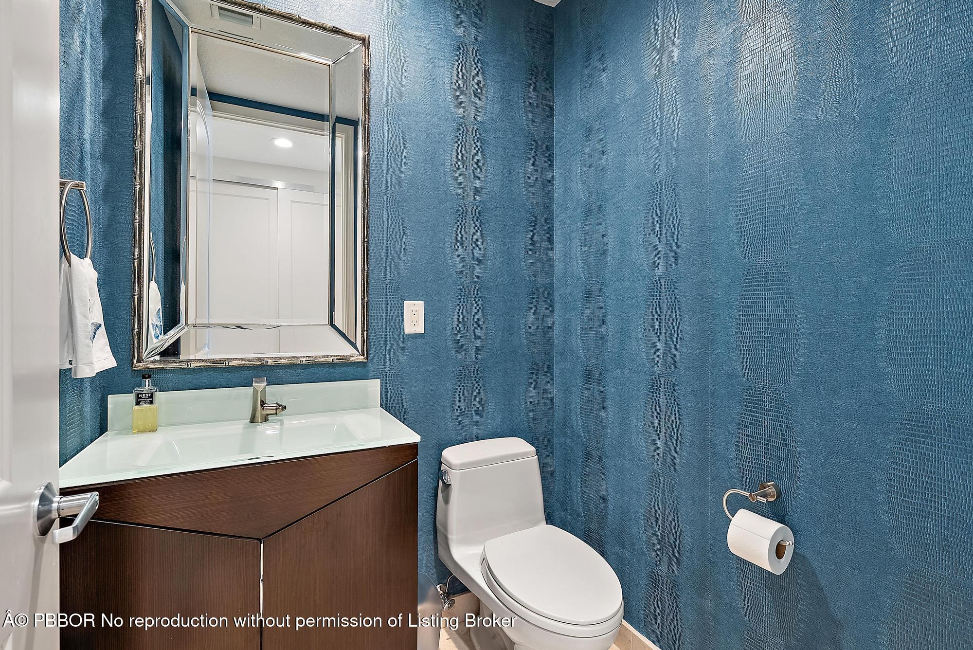 701 South Olive Avenue, Unit 2012 PH West Palm Beach, FL 33401 - Photo 16 of 42 a bathroom with a toilet a sink and mirror