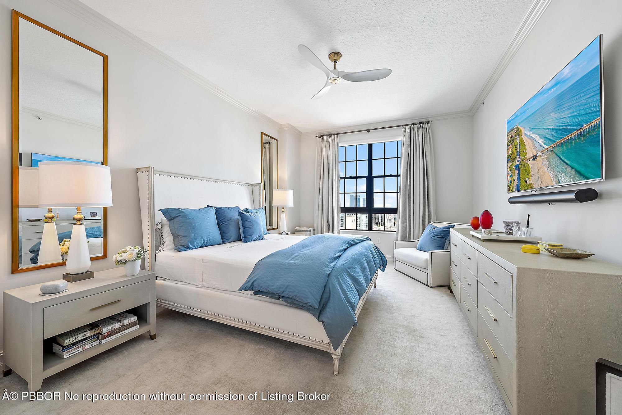 701 South Olive Avenue, Unit 2012 PH West Palm Beach, FL 33401 - Photo 18 of 42 a spacious bedroom with a bed and a large window