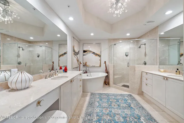 a bathroom with a double vanity sink a toilet a mirror and shower