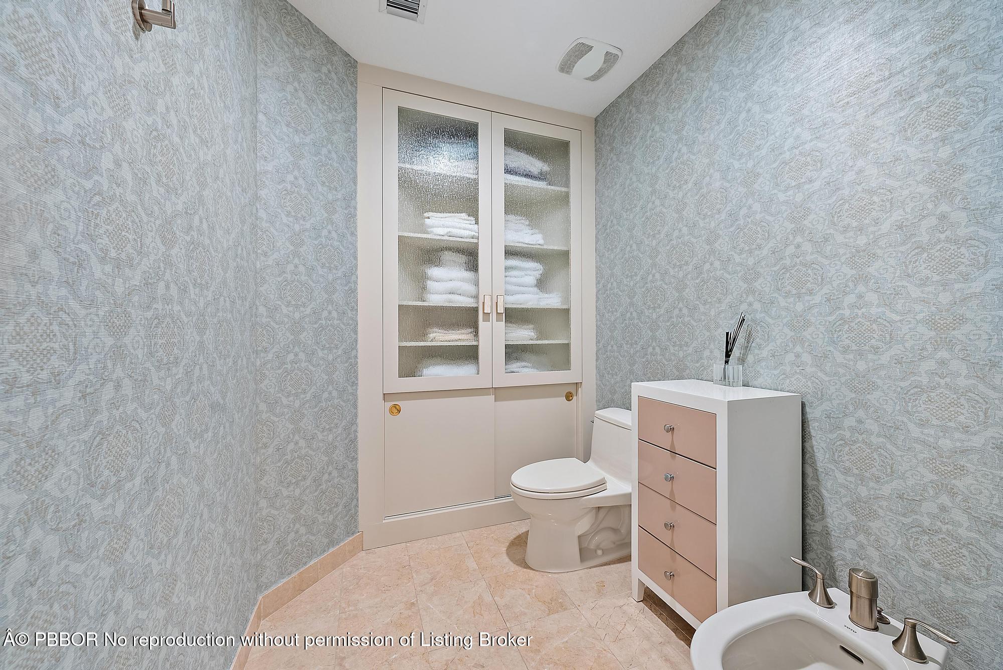 701 South Olive Avenue, Unit 2012 PH West Palm Beach, FL 33401 - Photo 21 of 42 a bathroom with a toilet a sink and a window