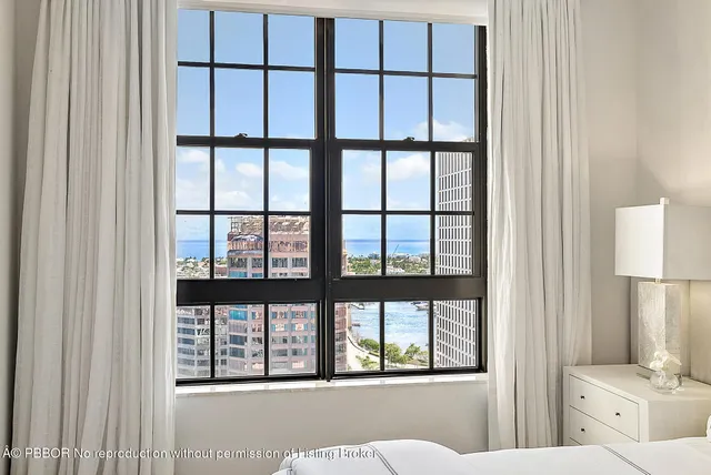a bathroom with a shower sink mirror and toilet