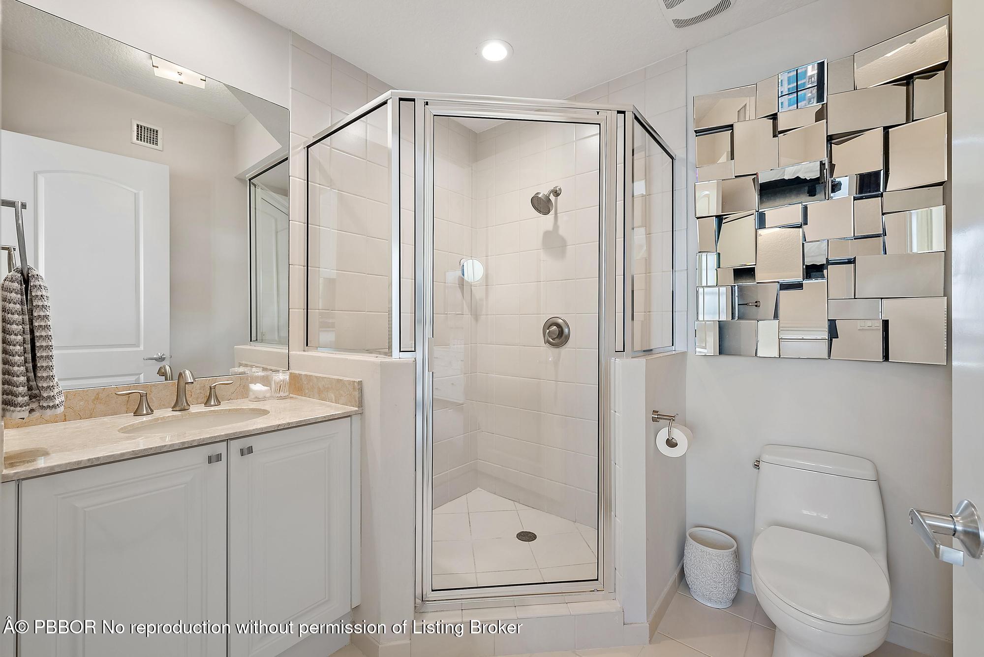 701 South Olive Avenue, Unit 2012 PH West Palm Beach, FL 33401 - Photo 24 of 42 a bathroom with a shower sink mirror and toilet
