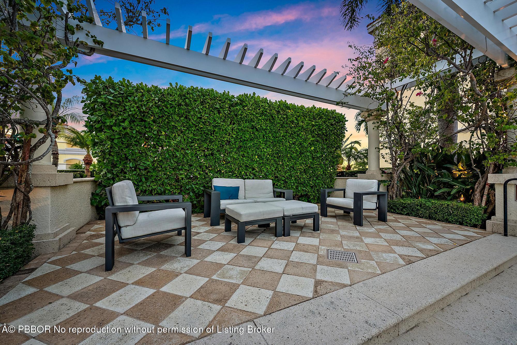 701 South Olive Avenue, Unit 2012 PH West Palm Beach, FL 33401 - Photo 34 of 42 a view of a patio with table and chairs with wooden floor and fence