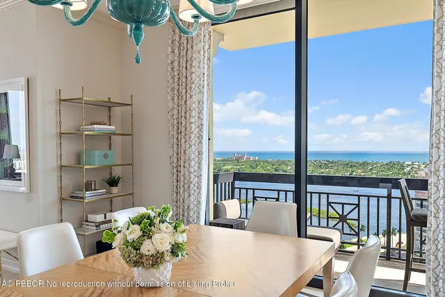 a view of a dining room with furniture a chandelier and wooden floor