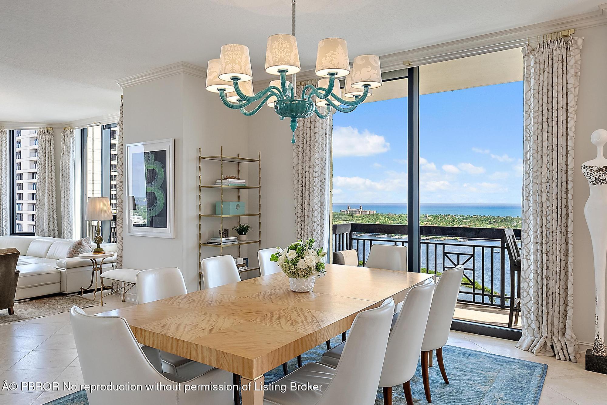 701 South Olive Avenue, Unit 2012 PH West Palm Beach, FL 33401 - Photo 10 of 42 a view of a dining room with furniture a chandelier and wooden floor