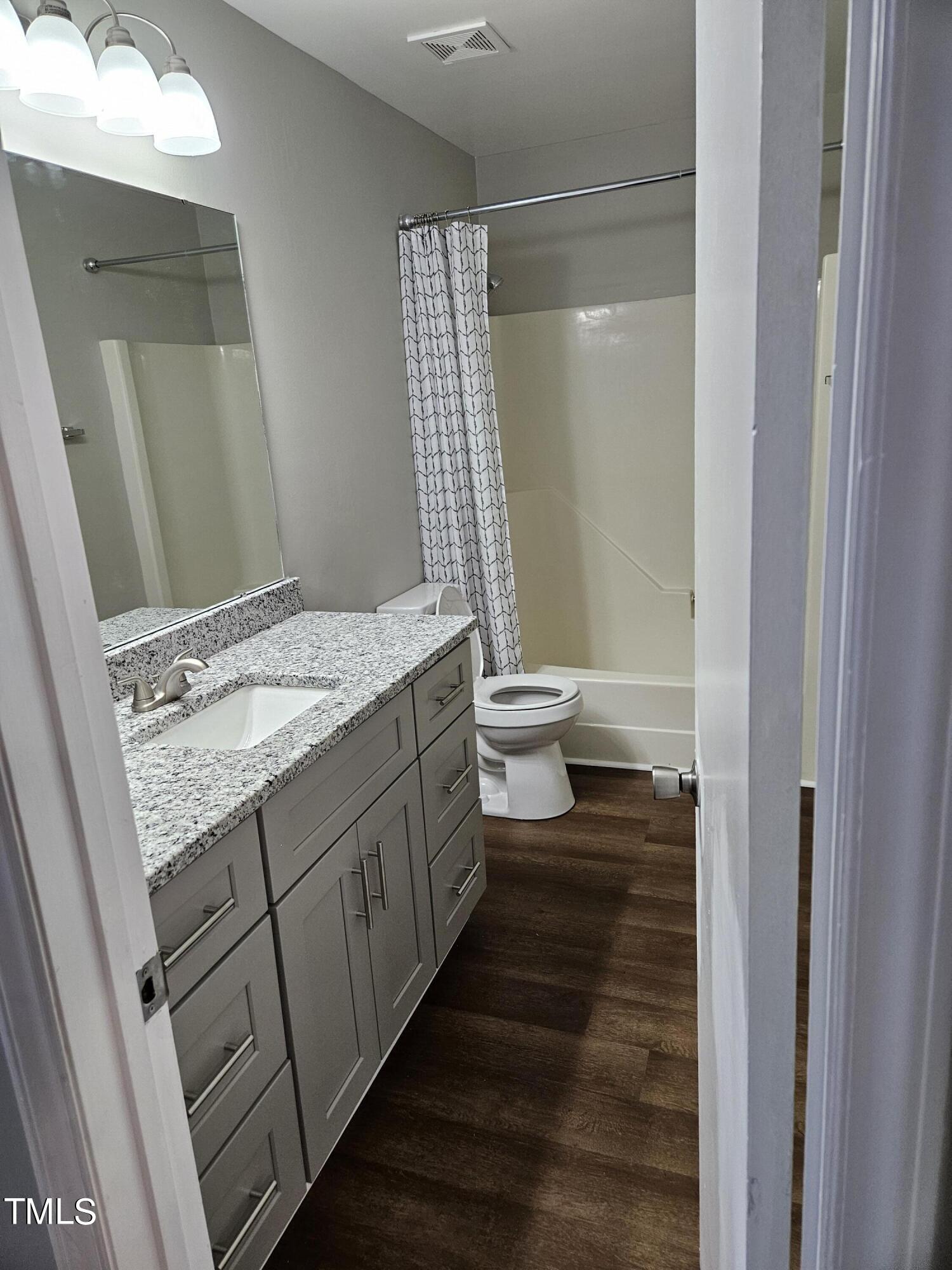 1629 Beverly Road Rocky Mount, NC 27801 - Photo 13 of 13 a bathroom with a granite countertop sink toilet and shower