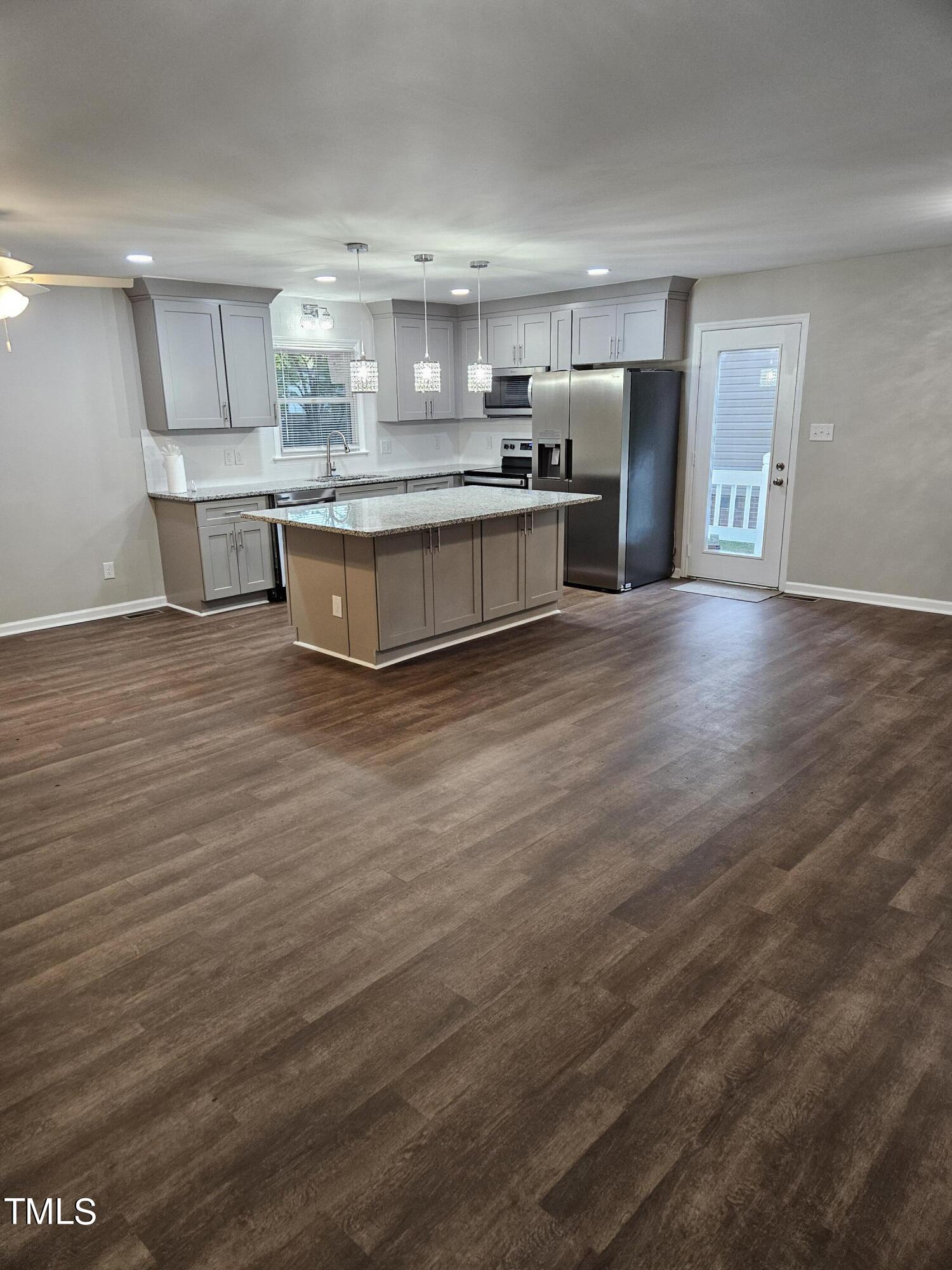 1629 Beverly Road Rocky Mount, NC 27801 - Photo 4 of 13 a large kitchen with stainless steel appliances granite countertop a large counter top and a stove with wooden floor