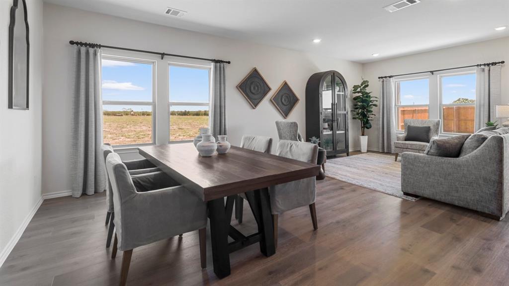 636 Dunham Road Nevada, TX 75173 - Photo 13 of 31 Open-concept living space featuring wood-finish flooring, recessed lighting, and multiple windows