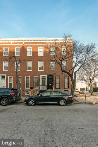a front view of a building with trees