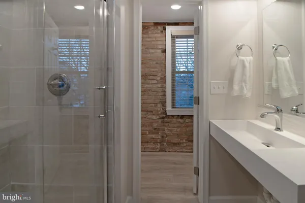 a living room with stainless steel appliances kitchen island granite countertop furniture a sink a rug and a window