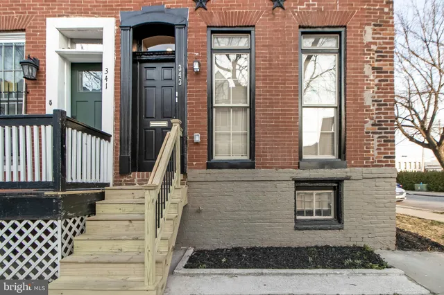 a view of a brick house with large windows