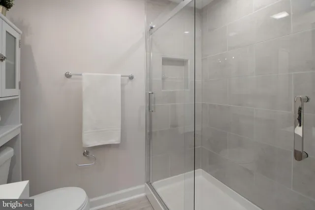 a bathroom with a shower sink and mirror
