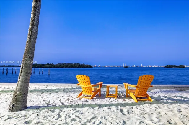 a view of a lake with a table and chairs