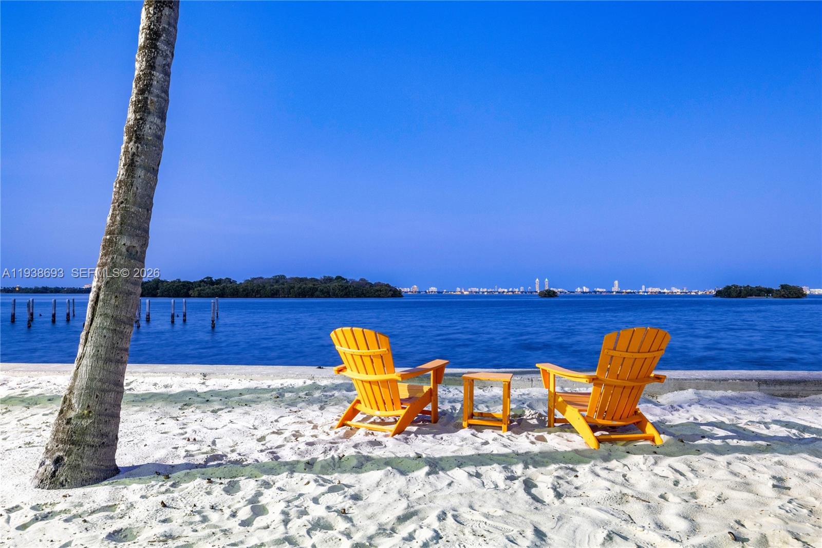 680 Northeast 64th Street, Unit APH2 Miami, FL 33138 - Photo 13 of 23 a view of a lake with a table and chairs