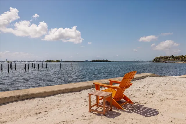 front view of a house with a large tree