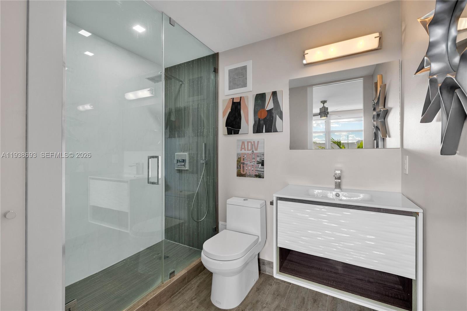 680 Northeast 64th Street, Unit APH2 Miami, FL 33138 - Photo 5 of 24 a bathroom with a sink a toilet and shower