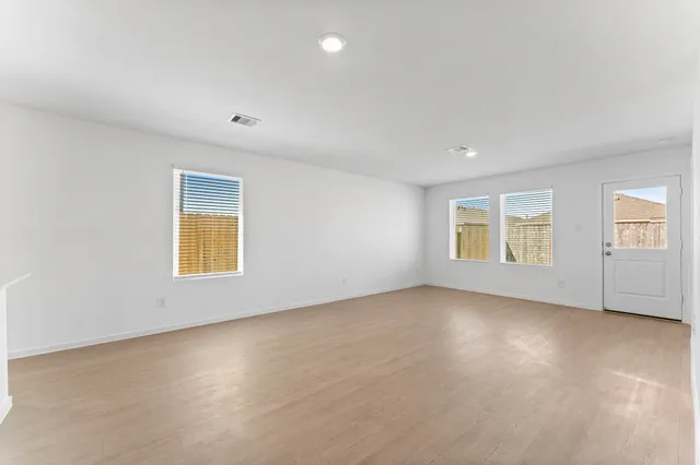 a view of kitchen with kitchen island white cabinets and stainless steel appliances