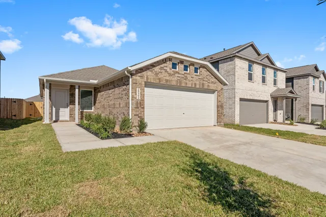 a view of a house with a yard and garage