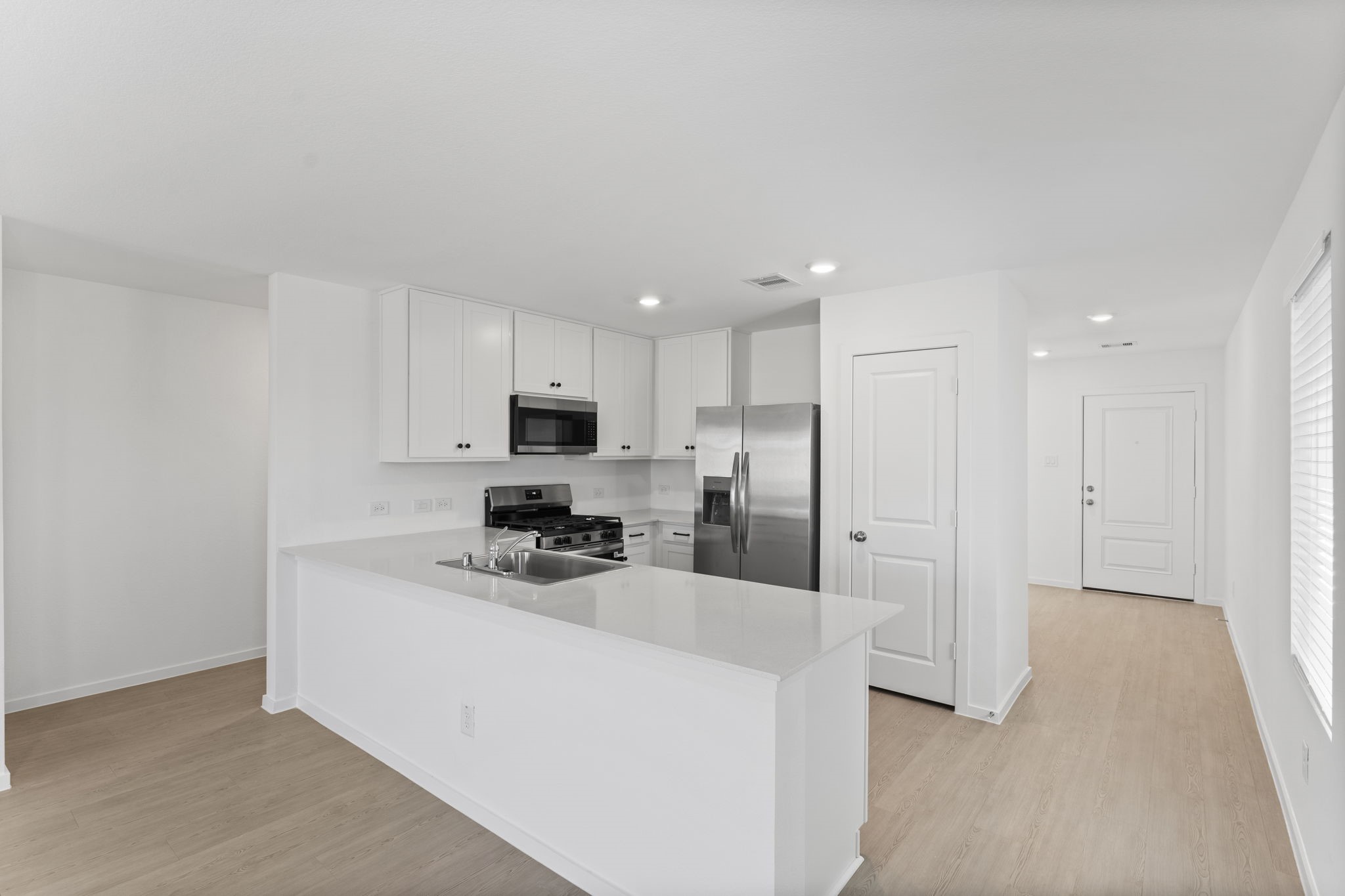 25392 Carnation Court Montgomery, TX 77316 - Photo 7 of 31 a kitchen with stainless steel appliances a refrigerator sink and microwave