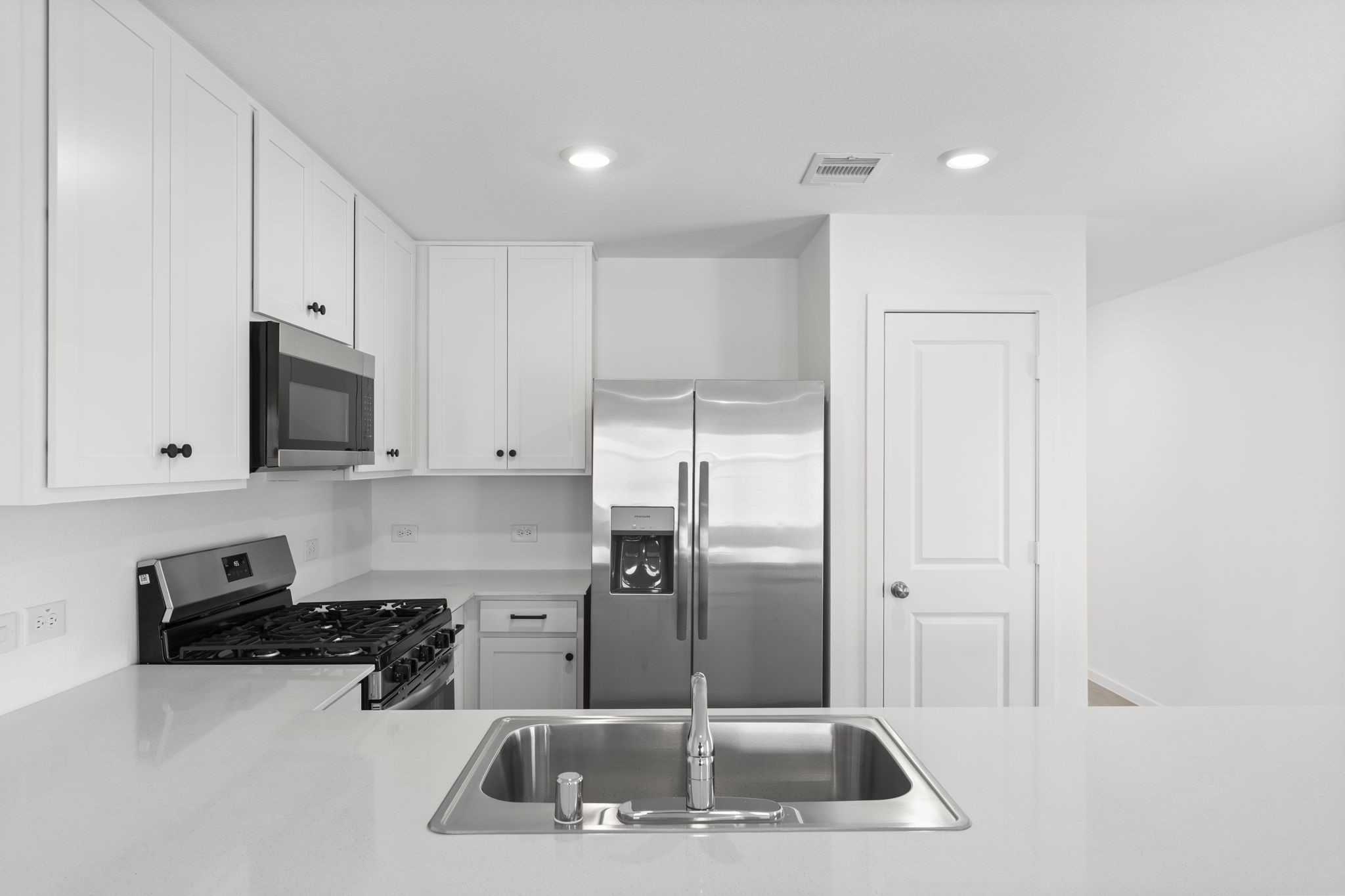 25392 Carnation Court Montgomery, TX 77316 - Photo 9 of 31 a kitchen with stainless steel appliances granite countertop a sink a stove and a refrigerator