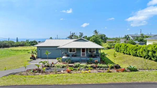 a view of a house with a yard and lake view